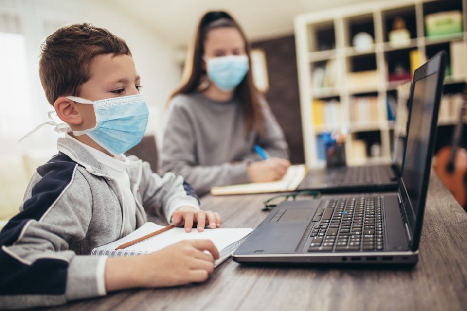 Kids learning together at home may need to wear masks and social-distance, among taking other precautions. (Getty Images)