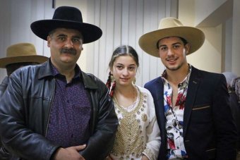 Perty with her teenage husband Young girl stands in between an older man and a teenage boy.
