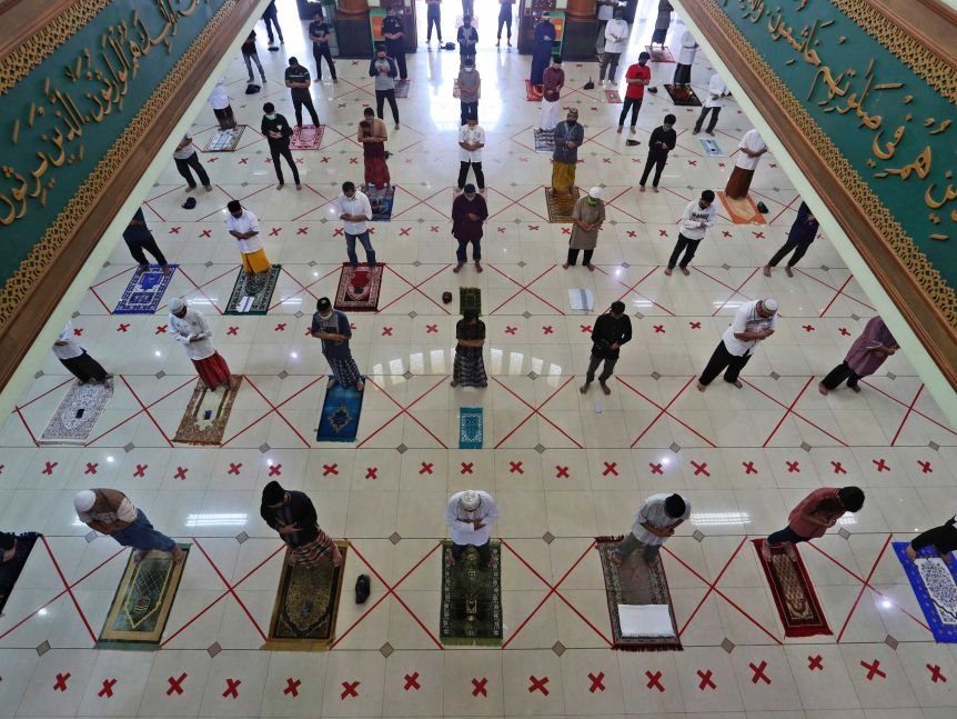 Muslims pray spaced apart to help curb the spread of the coronavirus during a Friday prayer.