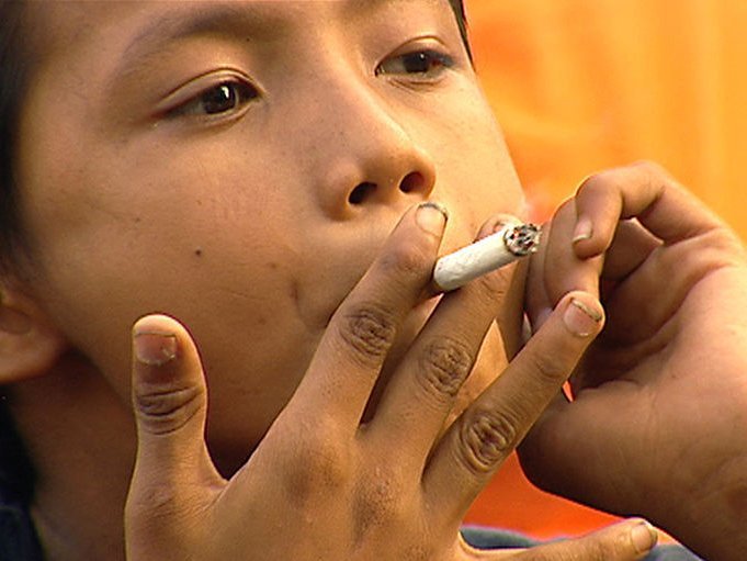 A child smokes a cigarette in Indonesia.