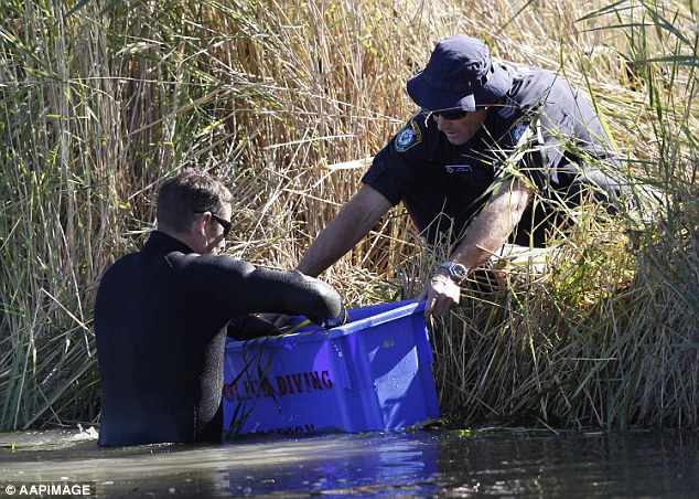 A police diver searches an irrigation channel on the outskirts of Leeton on April 10, 2015, the day after Vincent Stanford was charged with murdering Stephanie Scott. Her laptop was found