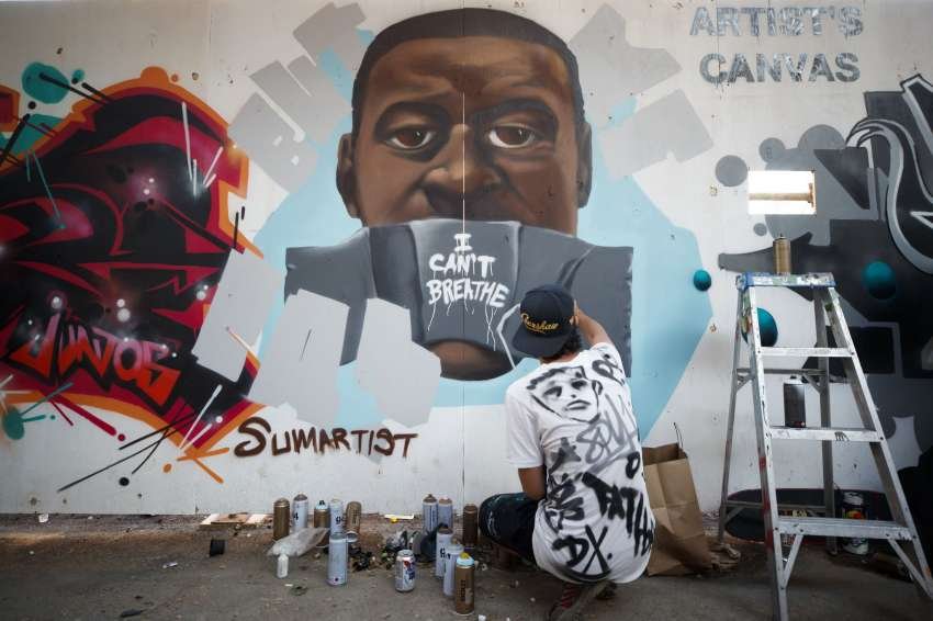 Artist Paul Glyn-Williams painted this mural of Floyd in Toronto, Canada. Here, he can be seeing adding finishing touches.
