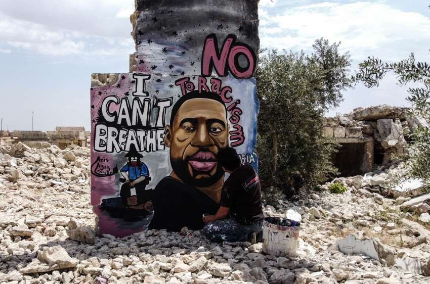 Thirty-six-year-old graffiti artist Aziz Asmar paints a mural depicting of George Floyd on a wall of house ruins in Binnish district in Idlib province, Syria on June 02.