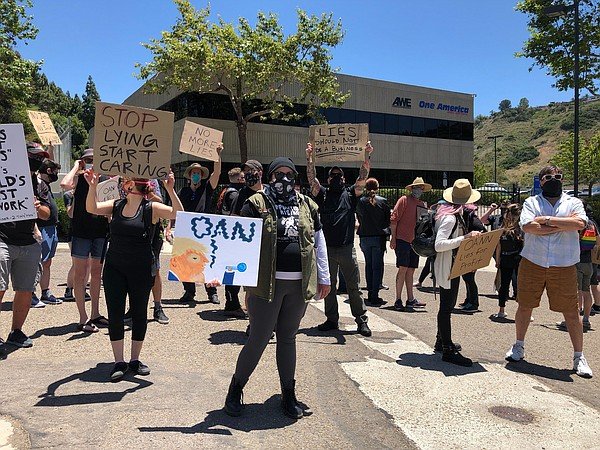 Protesters gather at the One American News Network (OAN) ...