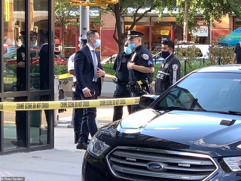 NYPD crime scene detectives are pictures on scene, outside the apartment block