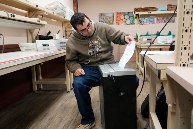 Daniel Rivera, of Wayne, shreds papers, at Found Abilities. Monday, October 17, 2022