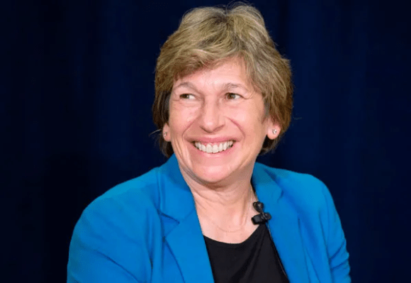 Randi Weingarten smiling in a blue blazer and black shirt. 