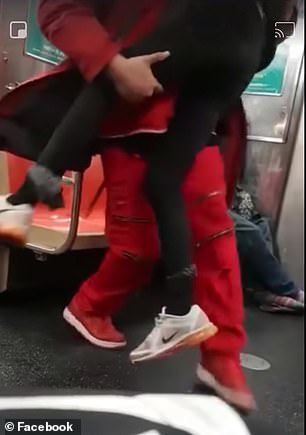 Sonny Alloway, dressed in red, at first tried to wake the woman as she slept on the train