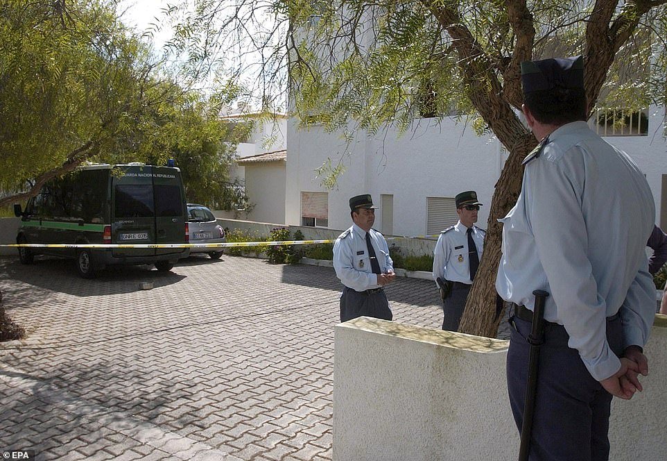 Taped-off: It was hours before the crime scene was protected. Portuguese police officers are pictured on duty in Praia da Luz