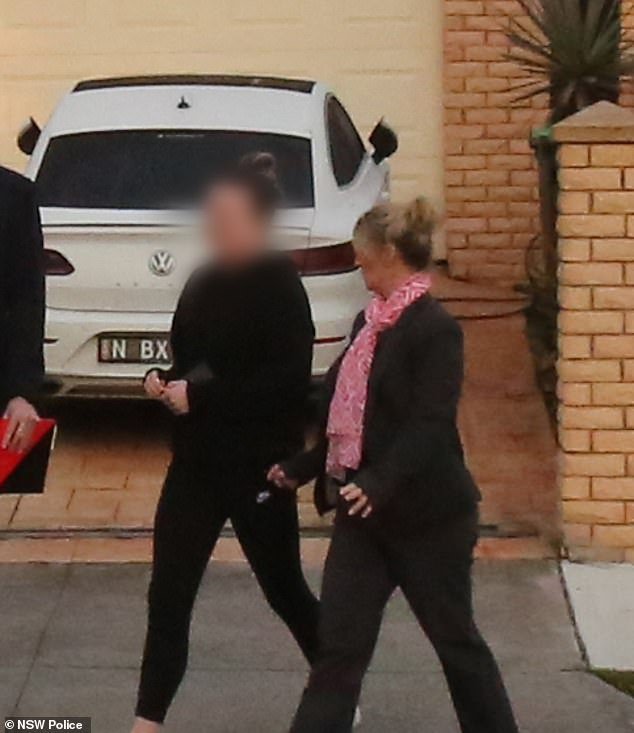 Officers, above, are filmed escorting Monica Young out of the premises of her home last Friday