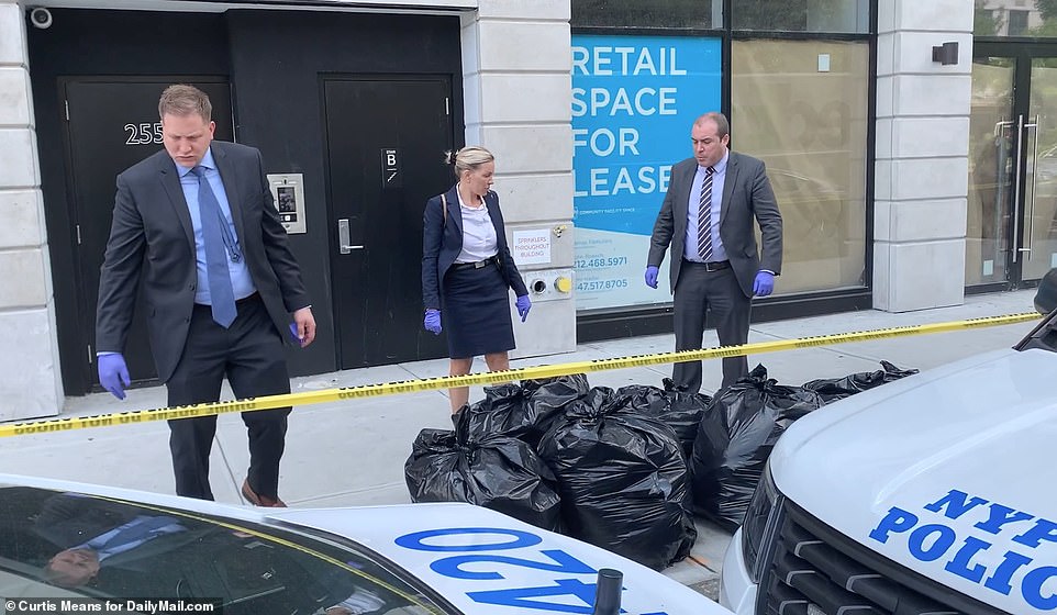Detectives outside the building on Wednesday. Police are yet to track down or arrest the killer