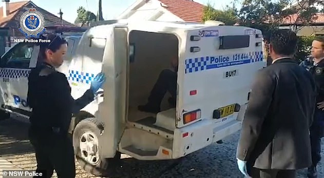 Simpson was put into the back of the police vehicle (pictured). He was taken to Burwood Police Station