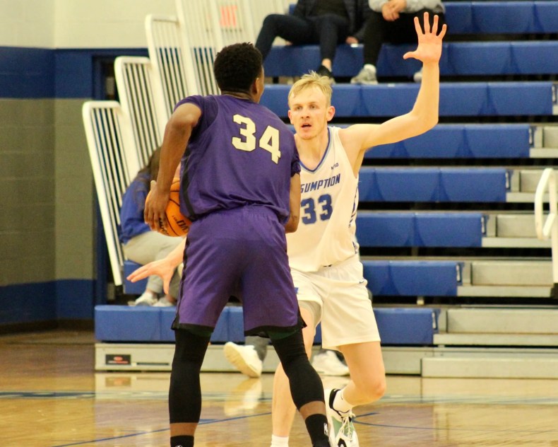 Former Bishop Connolly standout and 2018-19 Herald News Boys Basketball Player of the Year and current Assumption junior Cooper Creek covers St. Michael’s Joël Kabimba.