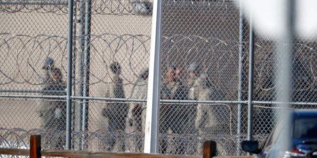 FILE - In this Feb. 18, 2020, file photo prisoners stand outside of the federal correctional institution in Englewood, Colo. Inmates at all 122 federal correctional facilities across the country will no longer be allowed visits from family, friends or attorneys for the next 30 days, in response to the threat of the coronavirus, officials told The Associated Press on Friday, March 13. (AP Photo/David Zalubowski, File)