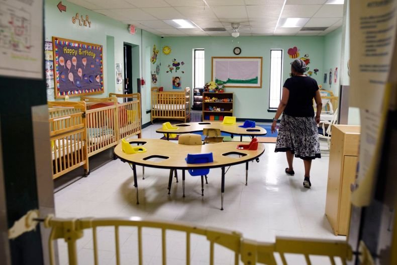 Dr. Ora Watson, owner and director of For Keeps Sake Child Care Academy, walks through an empty infant classroom at her child care academy in Dallas. On Tuesday the academy had one infant; before the pandemic the infant room catered to 10 kids a day.
