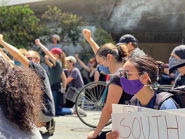 Protesters march through downtown San Diego in solidarity...