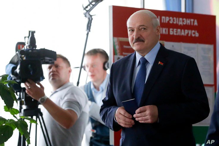 Belarusian President Alexander Lukashenko arrives to vote at a polling station during the presidential election in Minsk, Aug. 9, 2020. 