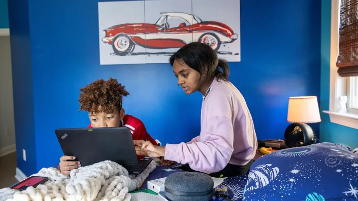 Brother and sister remote learning in Georgia during pandemic