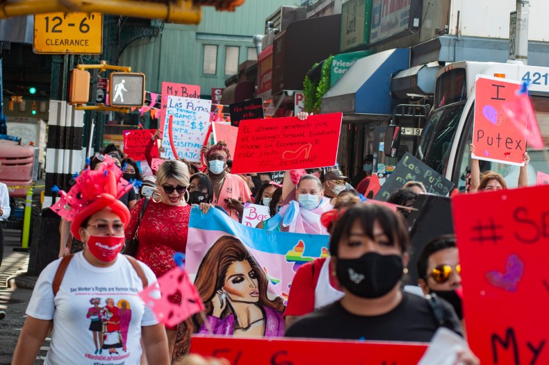 Street protest of people wearing face masks and holding signs demanding rights