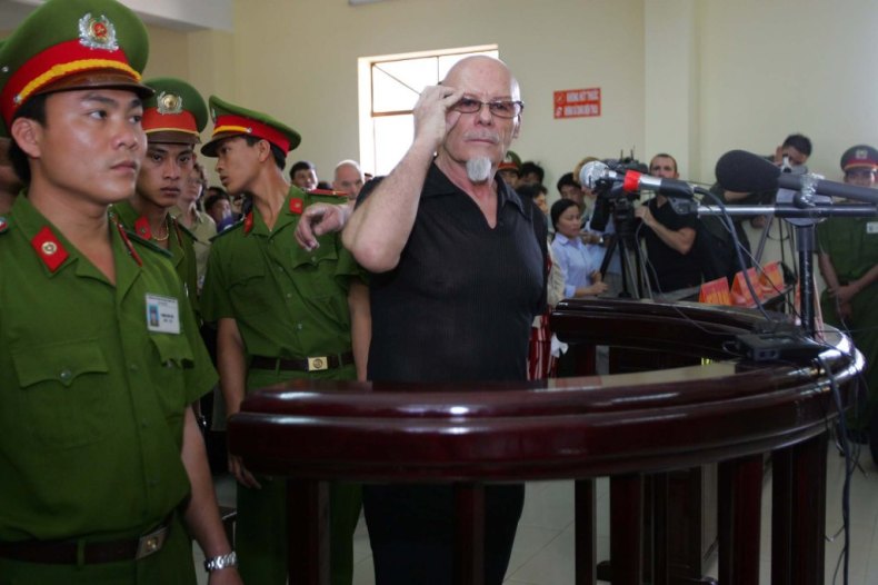 Gary Glitter listens to a guilty verdict being read out at the People's Courthouse on March 3, 2006 in Ba Ria, Vietnam.