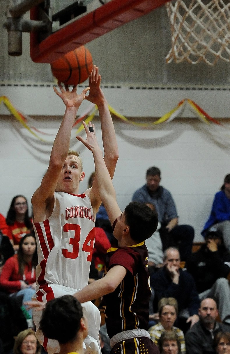 Bishop Connolly’s Cooper Creek pops up to shoot over Case’s Logan Sherratt during a 2019 non-league boys basketball game.