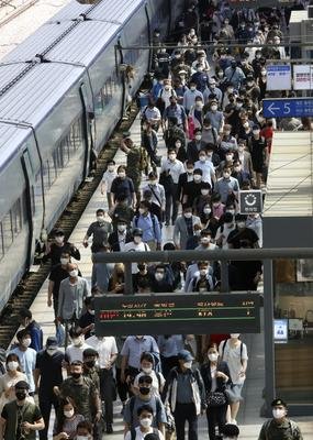 People get off the train at a railway station in Seoul (Ahn Young-joon/AP)