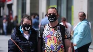 A couple wearing face masks shopping in Dublin&rsquo;s Henry Street (Niall Carson/PA)