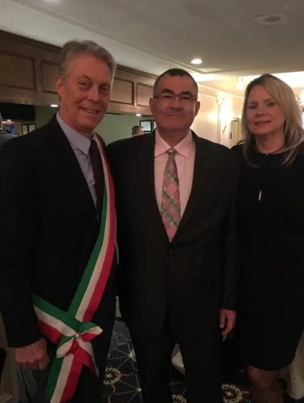 Hamilton Mayor Fred Eisenberger poses in 2018 with Pat Mostacci and his wife Gloria Mostacci. Eisenberger is wearing a traditional mayor's sash gifted to him by Mostacci and made by Mostacci's mother. Eisenberger later shared the photo on his Twitter page.