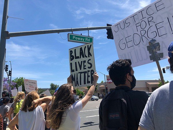 Protesters rally in Poway to denounce the death of George...