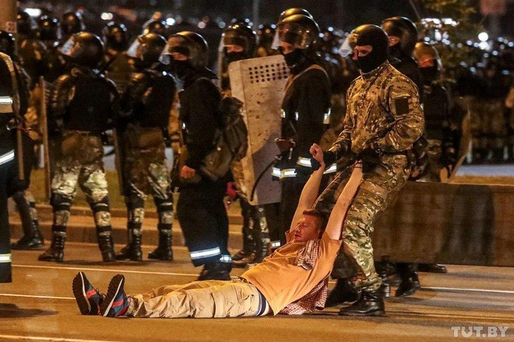 A law enforcement officer drags a man during clashes with opposition supporters after polls closed in presidential elections in Minsk, Belarus, Aug. 9, 2020. 