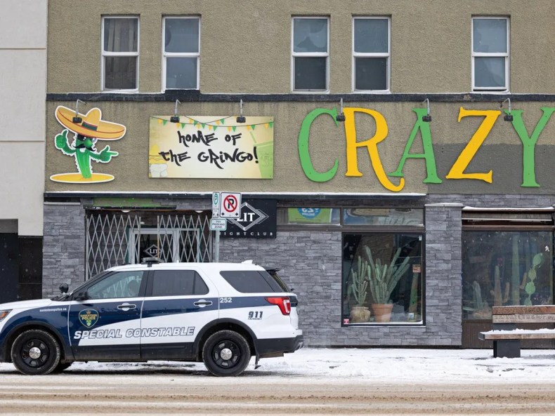 A file photo shows a Saskatoon police vehicle parked outside the Crazy Cactus bar on Nov. 7, two days after Hodan Hashi, 23, was stabbed to death there.