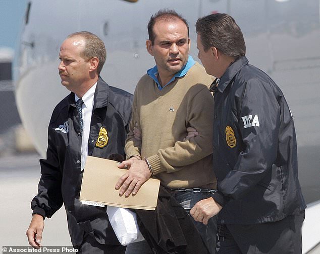 File image from May 13, 2008 shows Salvatore Mancuso (center) escorted by U.S. Drug Enforcement Agency agents in Opa-locka, Florida, after he extradition from Colombia.